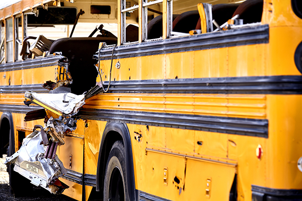 damage to the side of a yellow school bus