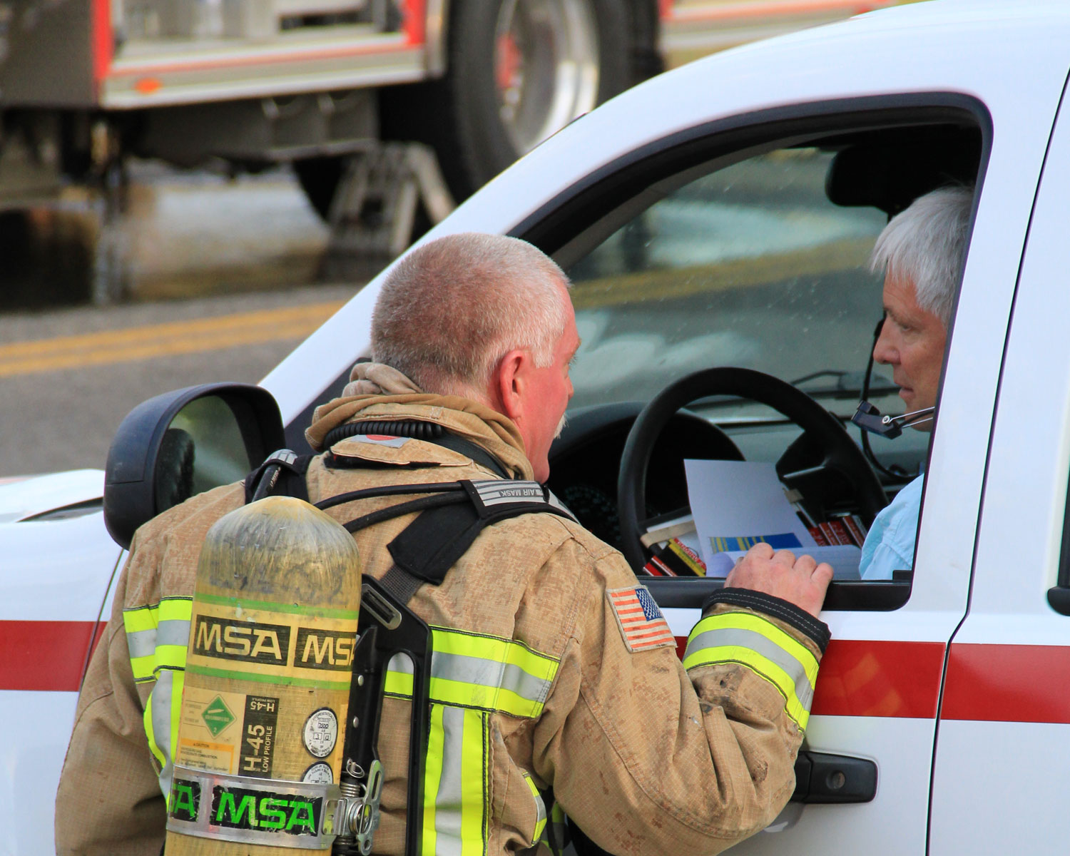Fireman talking to EMT