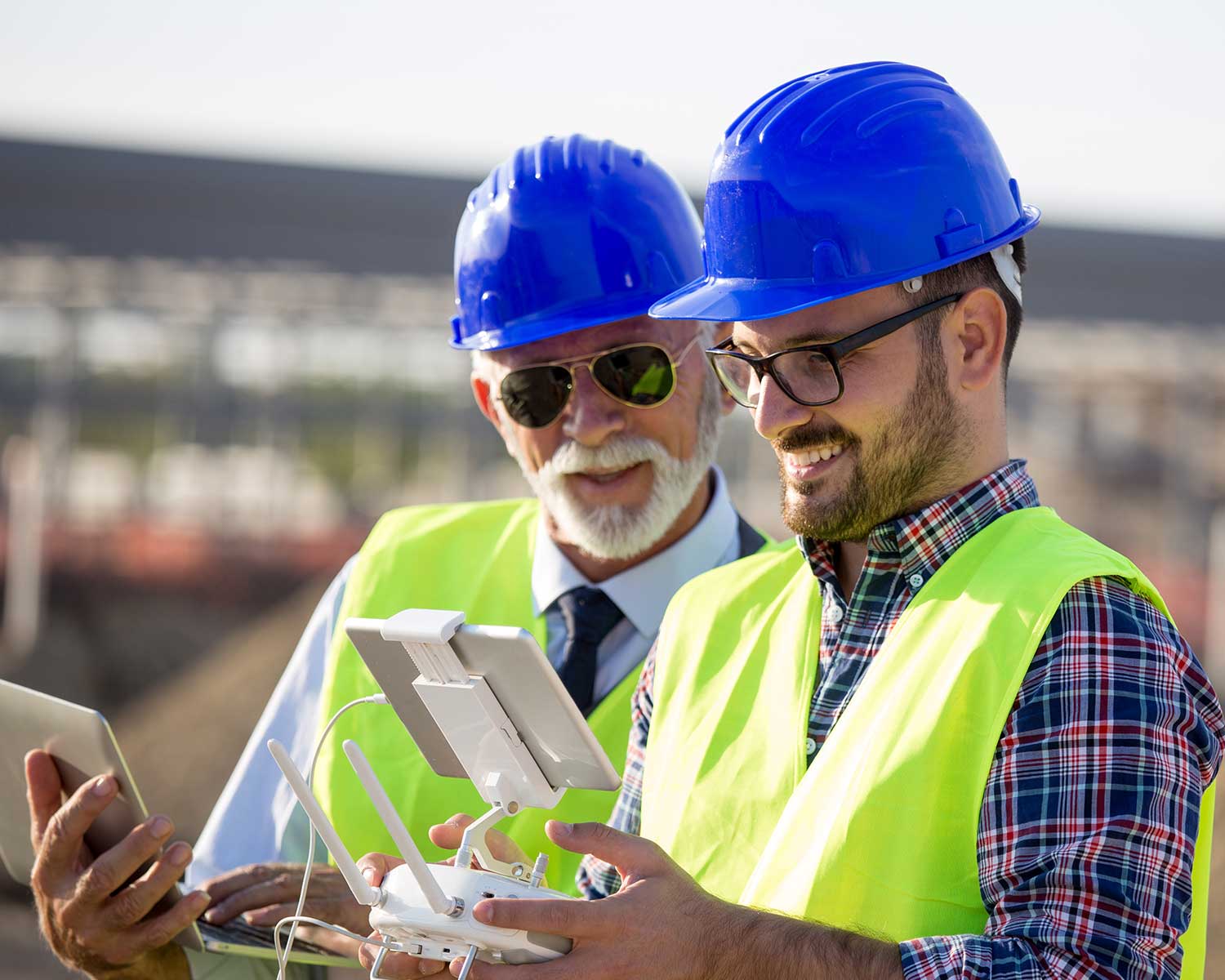 Workers using drone remote