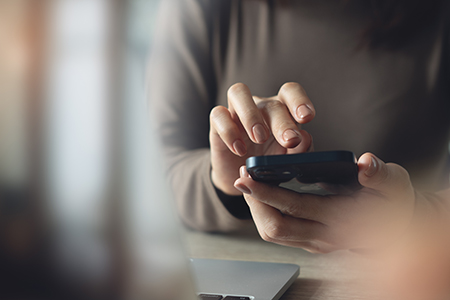 image of a woman's hands holding a cell phone