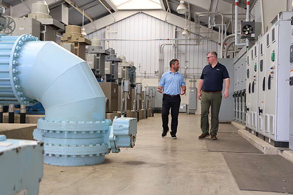 A client and a risk consultant walking inside of the water district facility